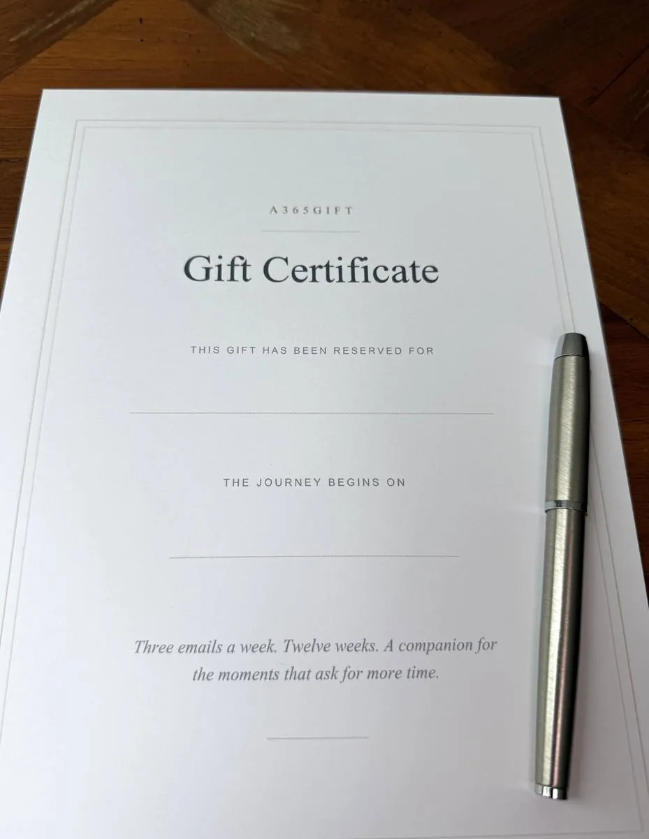 The blank printed gift certificate on a table with a pen beside it.